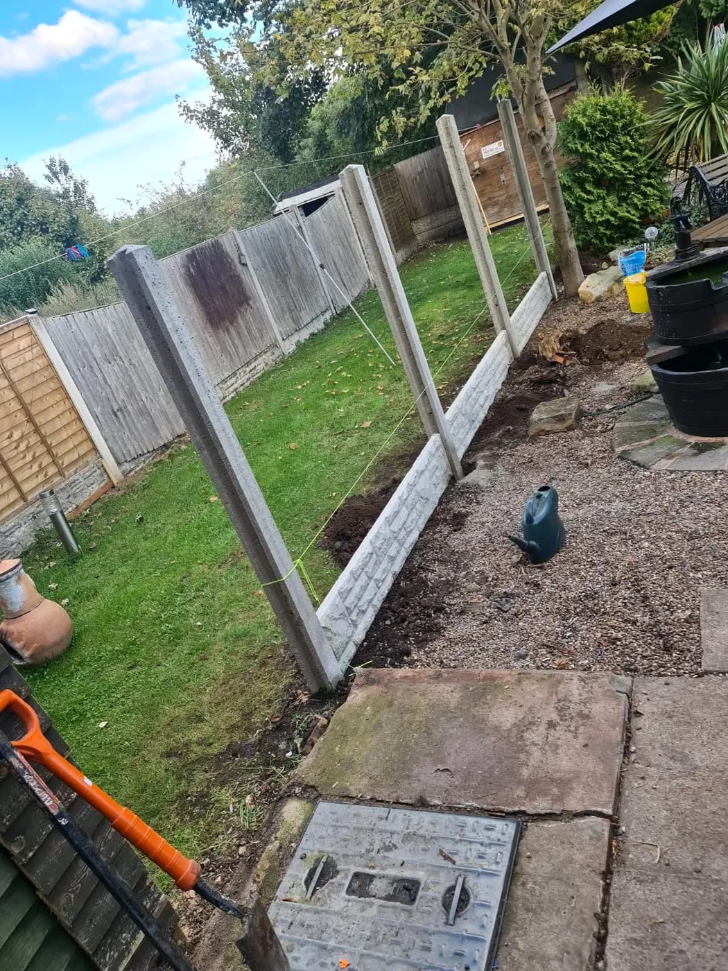 Concrete posts and gravel boards during the garden fence installation