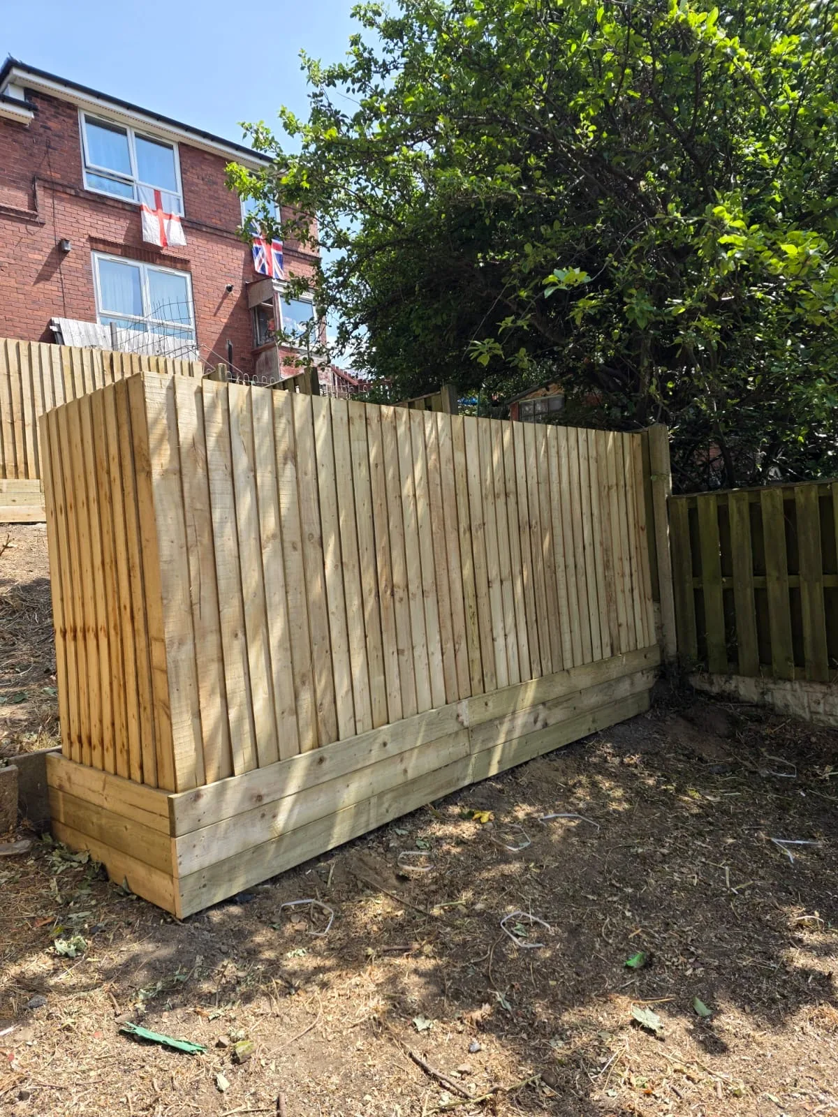 Completed timber fencing section around a garden boundary