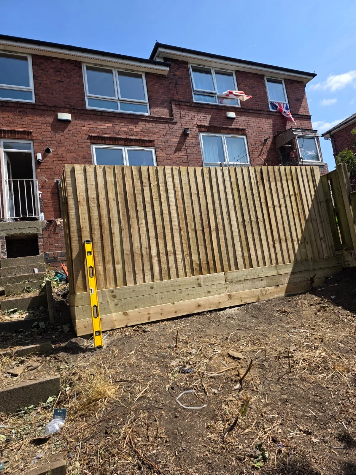 Completed vertical-board timber fence section
