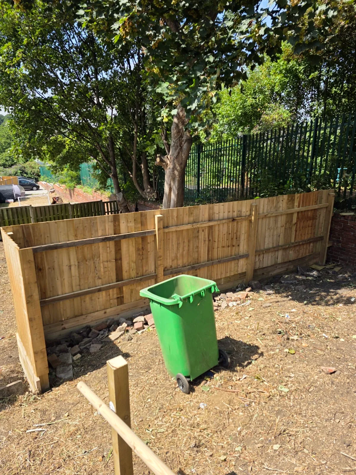 Partially completed timber boundary fence during installation