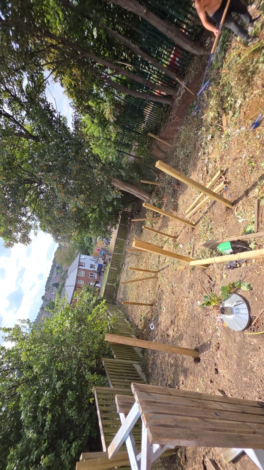 Timber fence posts positioned during the garden installation