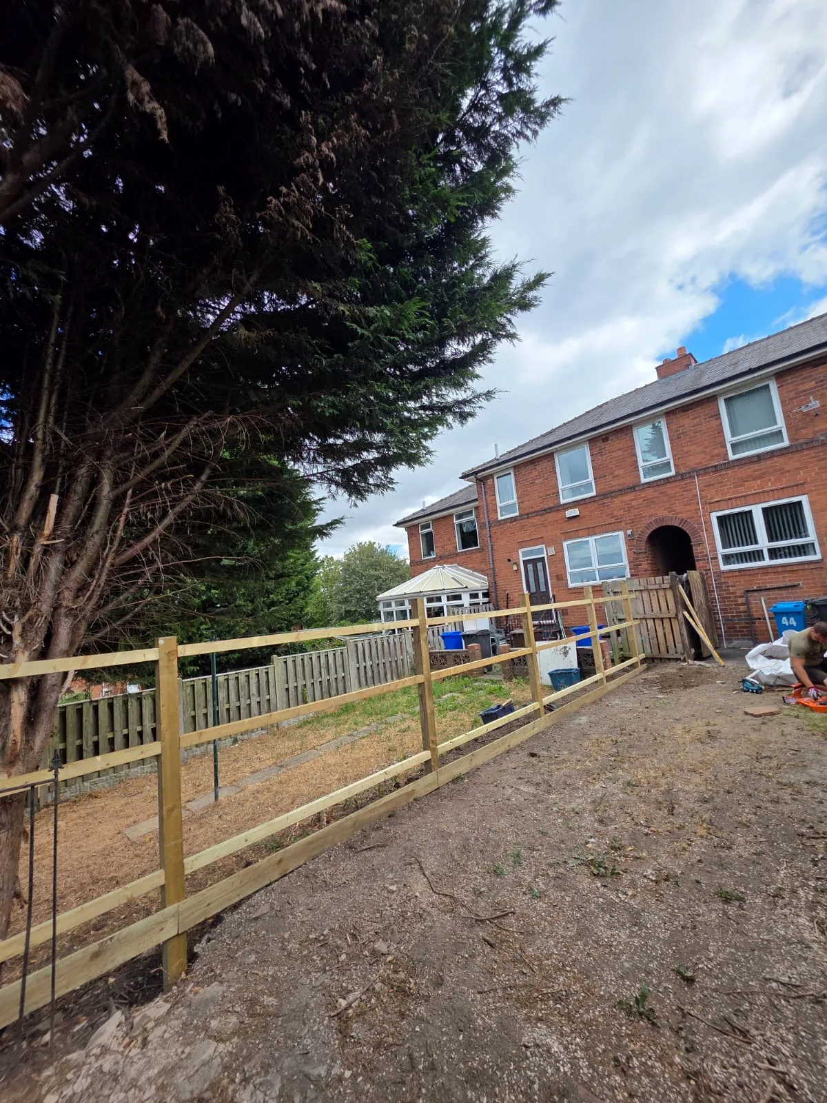 Long run of timber posts and rails before the fence boards were fitted