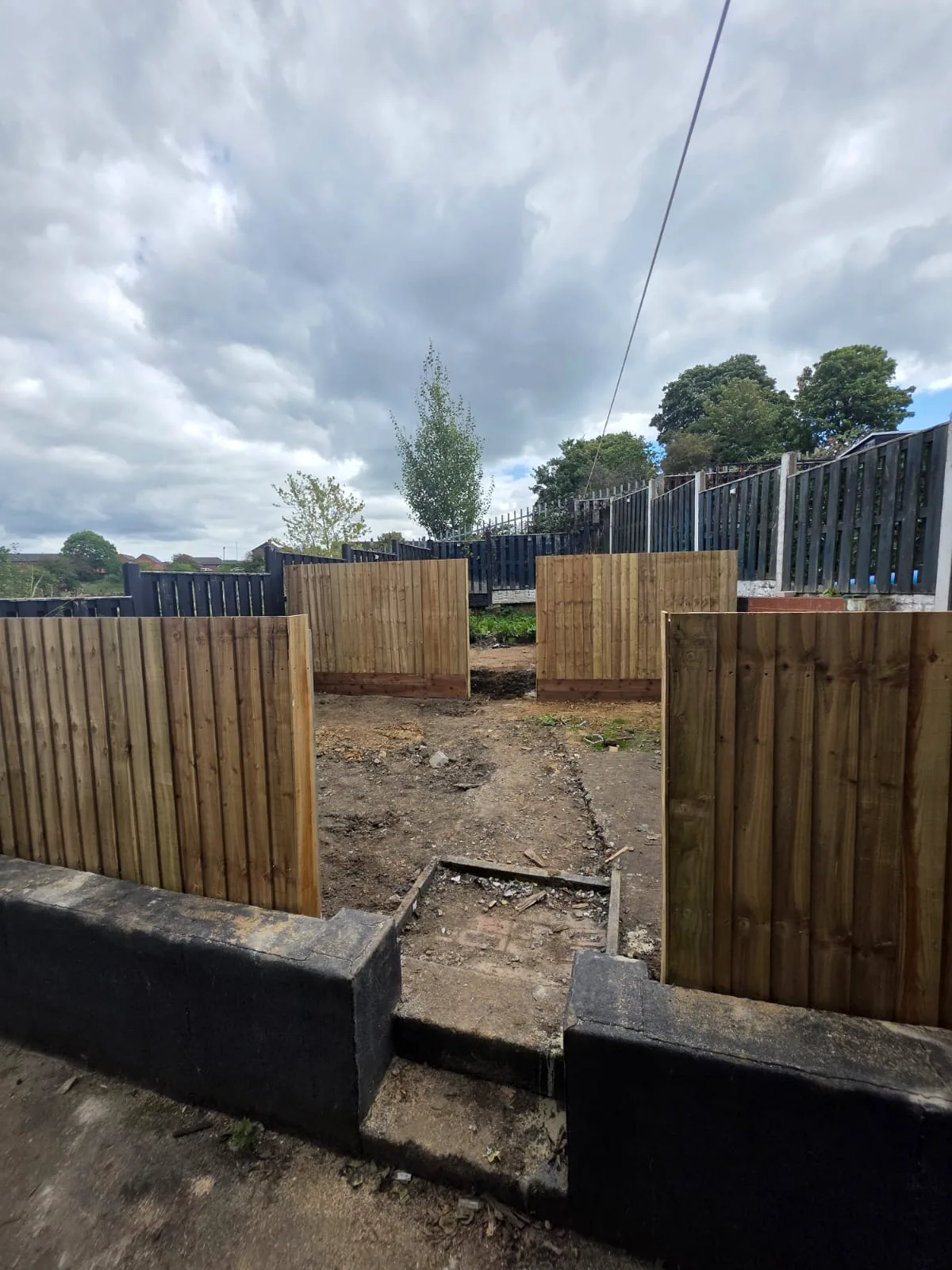Completed timber fence sections viewed across the garden levels