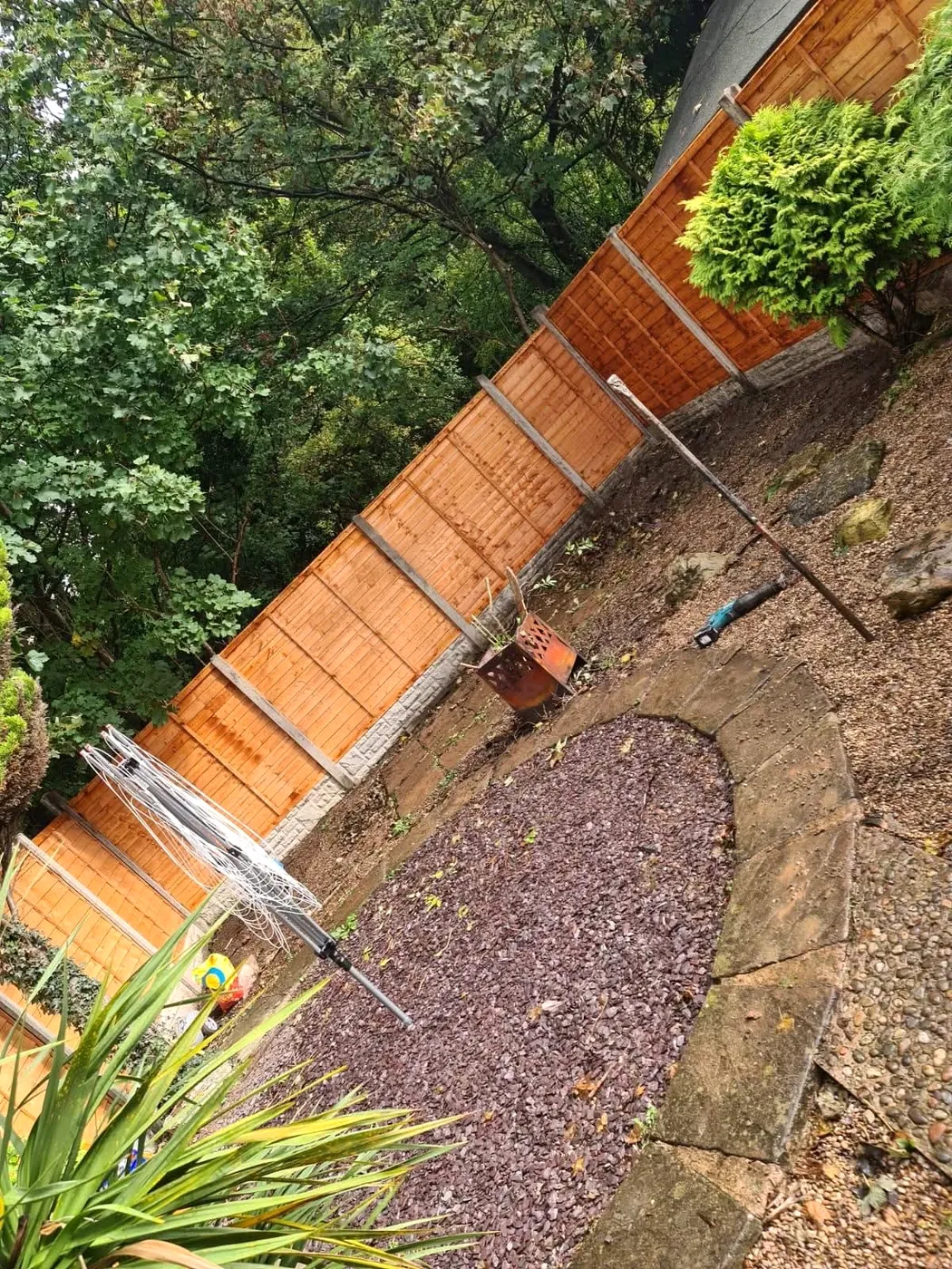 Completed timber panel fencing around a garden boundary