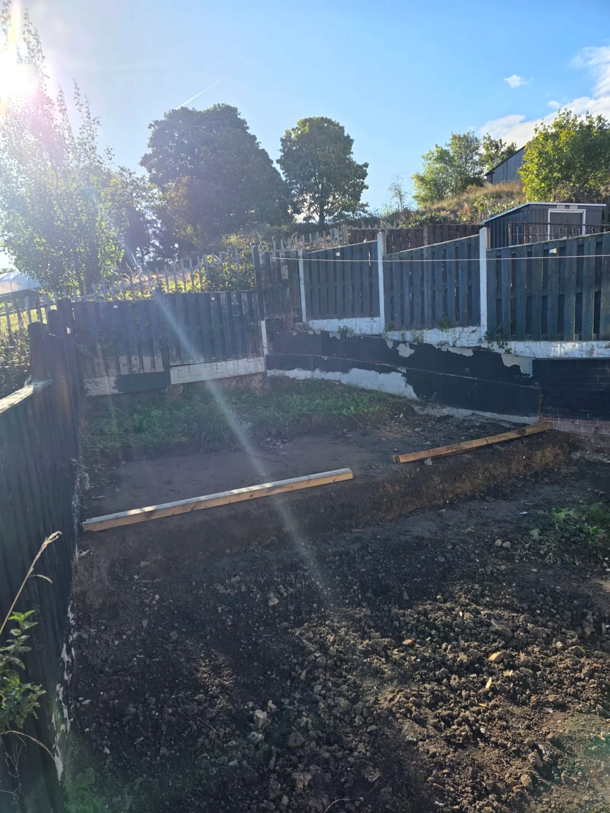 Prepared terraced garden boundary before fencing installation
