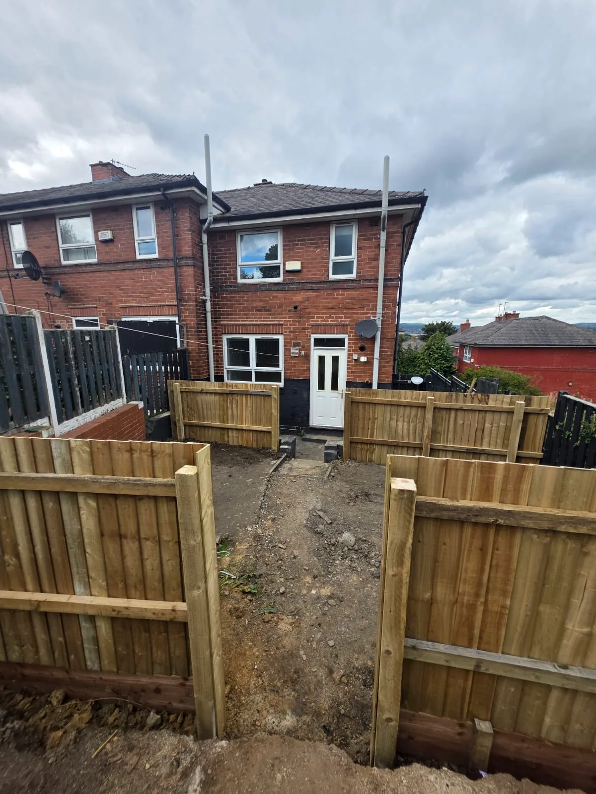 Completed timber fencing sections across a terraced garden