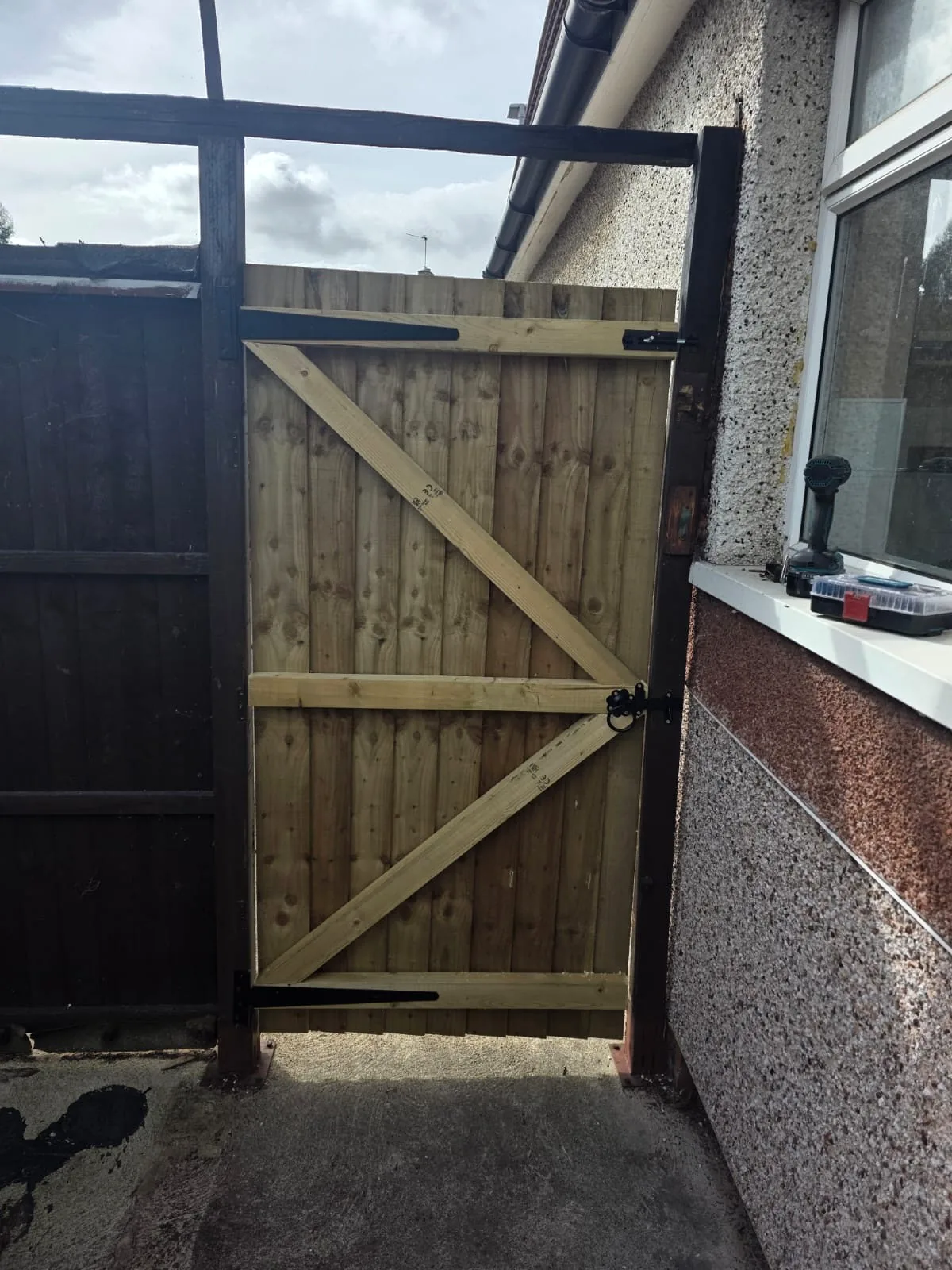 Completed braced timber side gate with black ironmongery