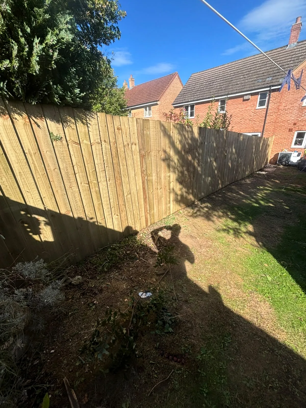 Completed timber garden fence viewed from the opposite end