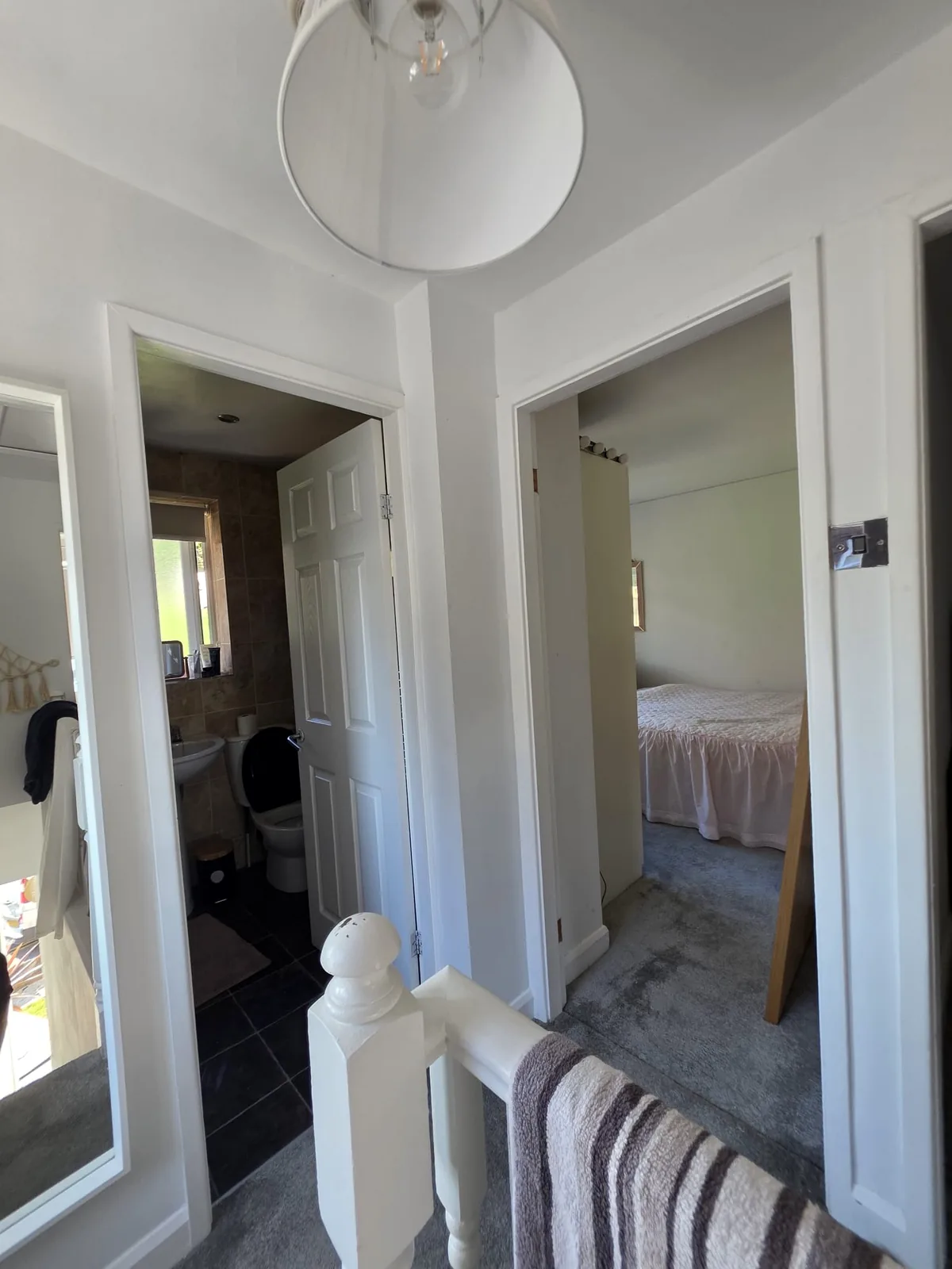Landing with white panelled internal doors before replacement